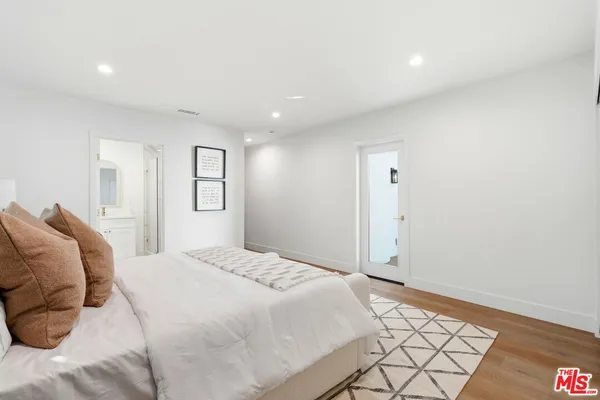 a bedroom with a bed and a painting