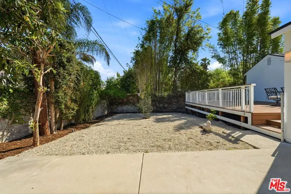 a view of a yard with large trees