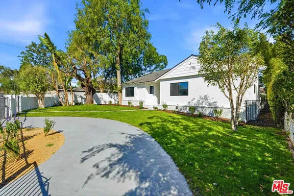 a view of house with backyard