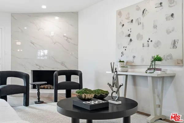 a living room with fireplace and furniture