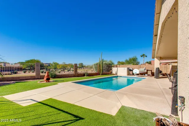 a view of a house with sitting area and swimming pool