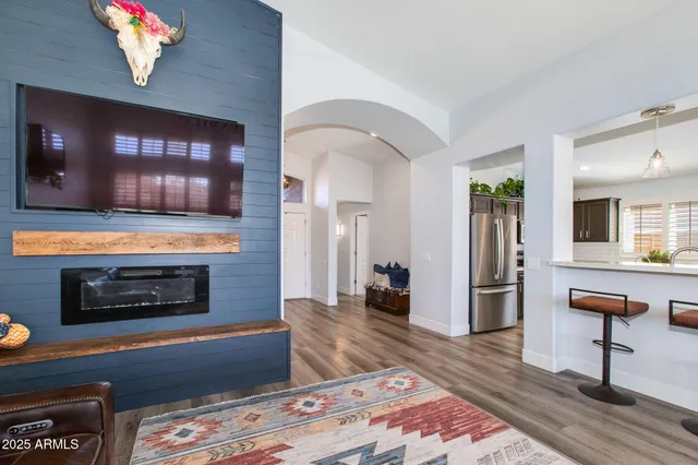 a view of a hallway with wooden floor and entryway