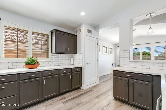 a kitchen with granite countertop a refrigerator stove and microwave