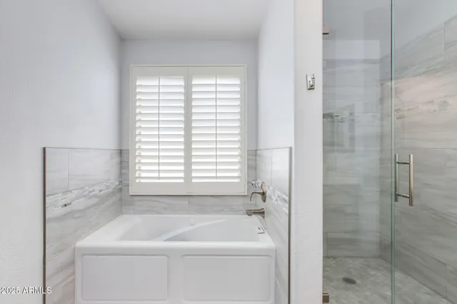 a bedroom with bed and window