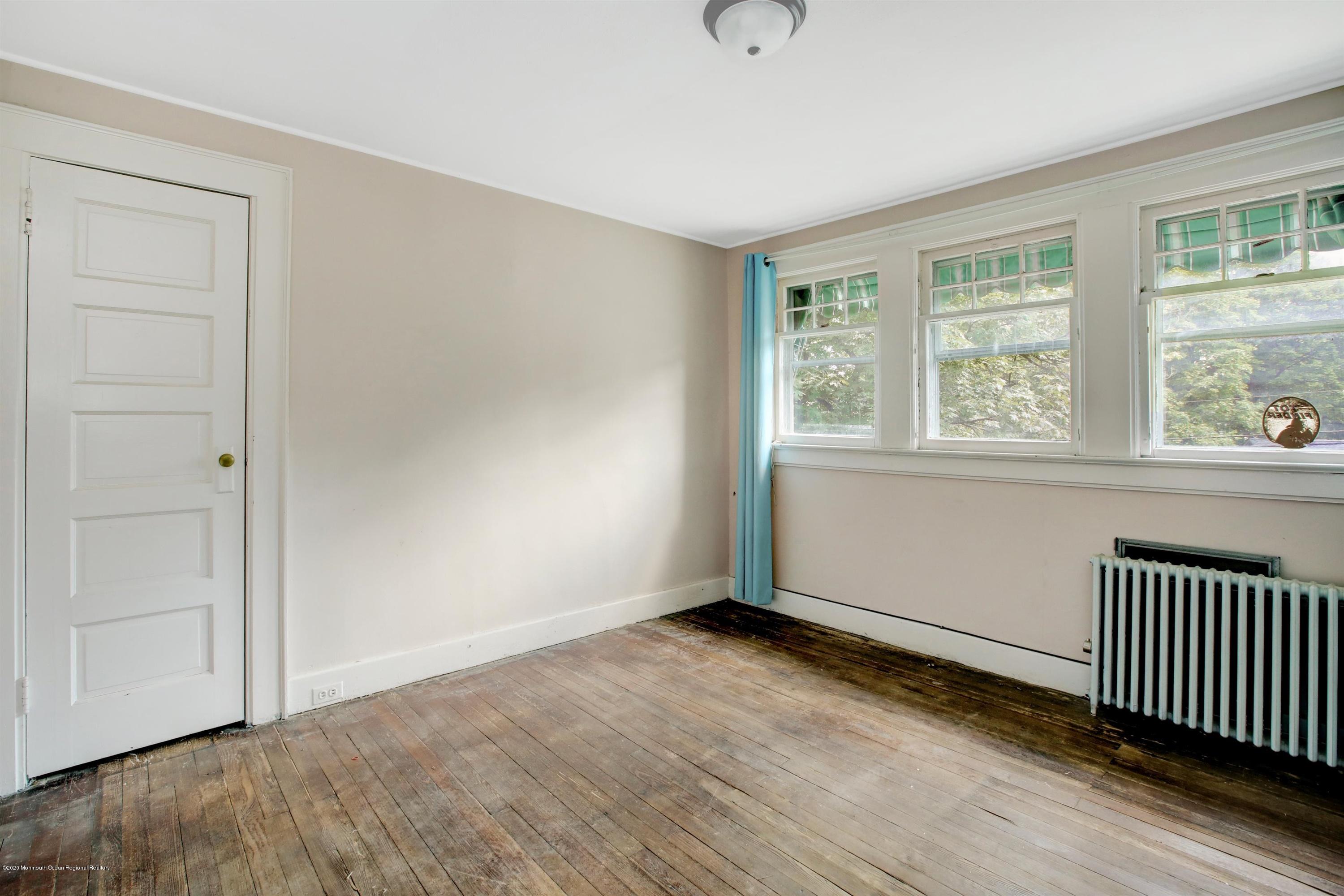 474 E Road Belford, NJ 07718 - Photo 12 of 32 an empty room with wooden floor and windows