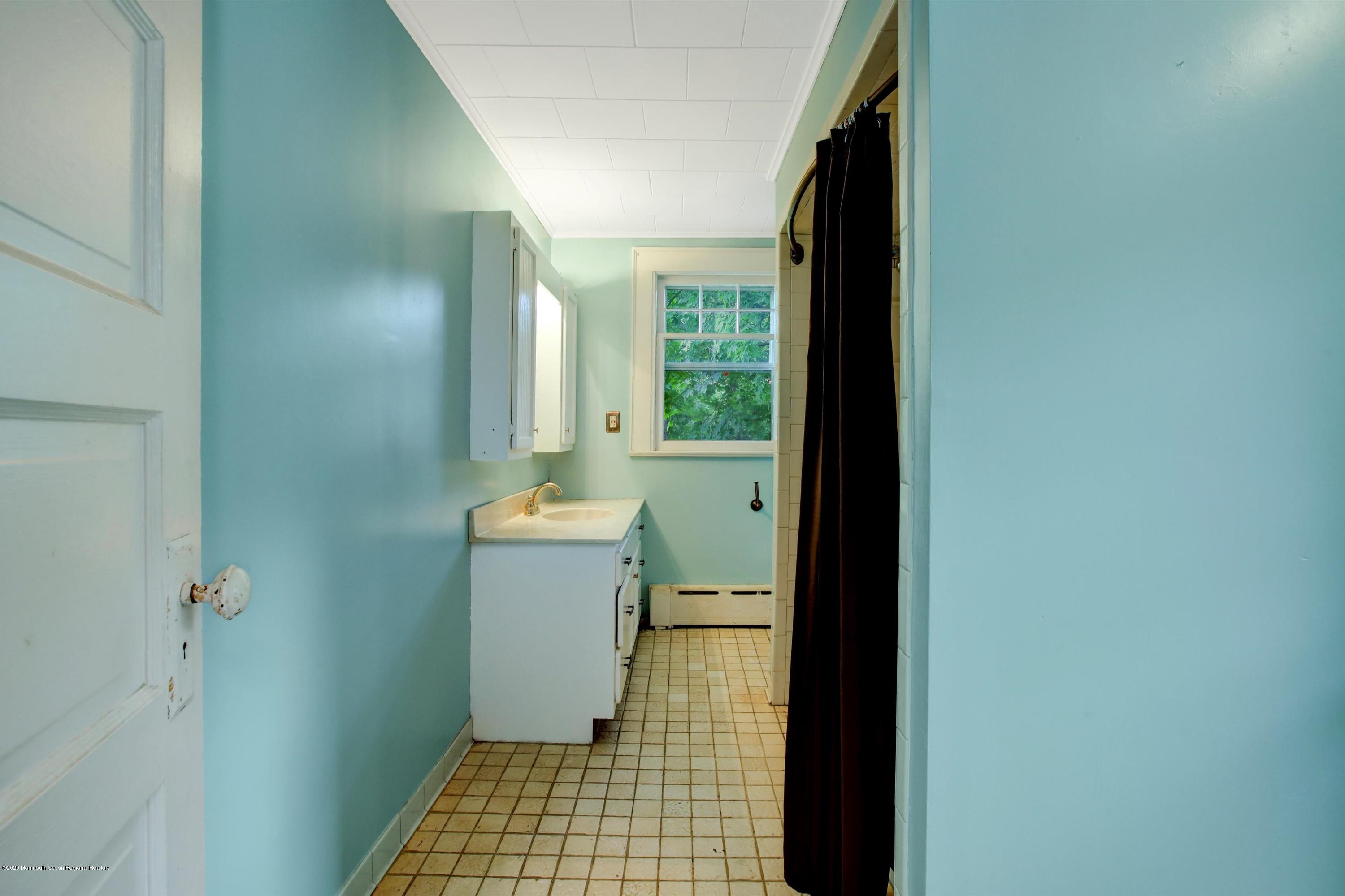 474 E Road Belford, NJ 07718 - Photo 14 of 32 a bathroom with a sink a toilet and shower