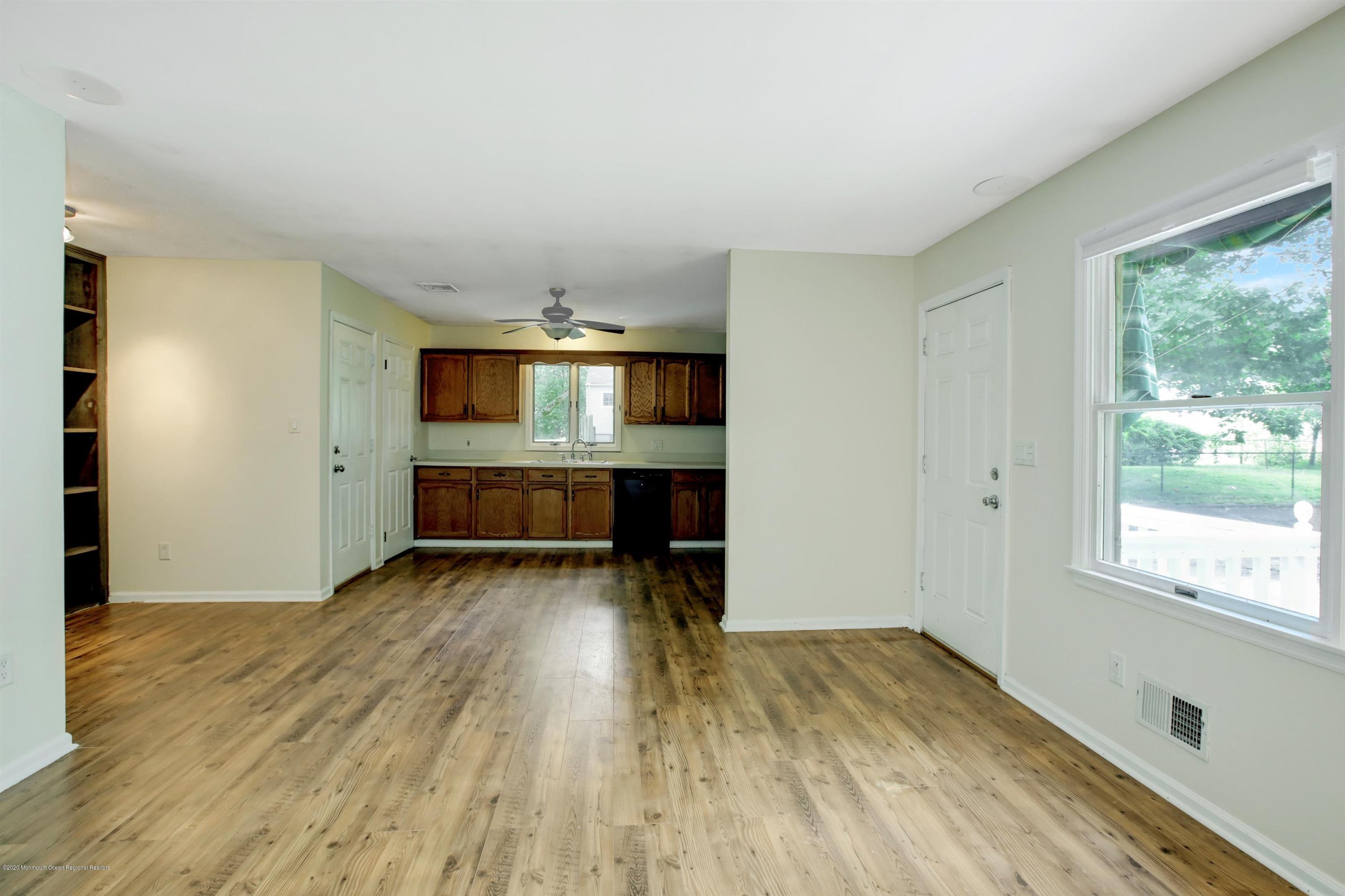 474 E Road Belford, NJ 07718 - Photo 16 of 32 an empty room with wooden floor and windows
