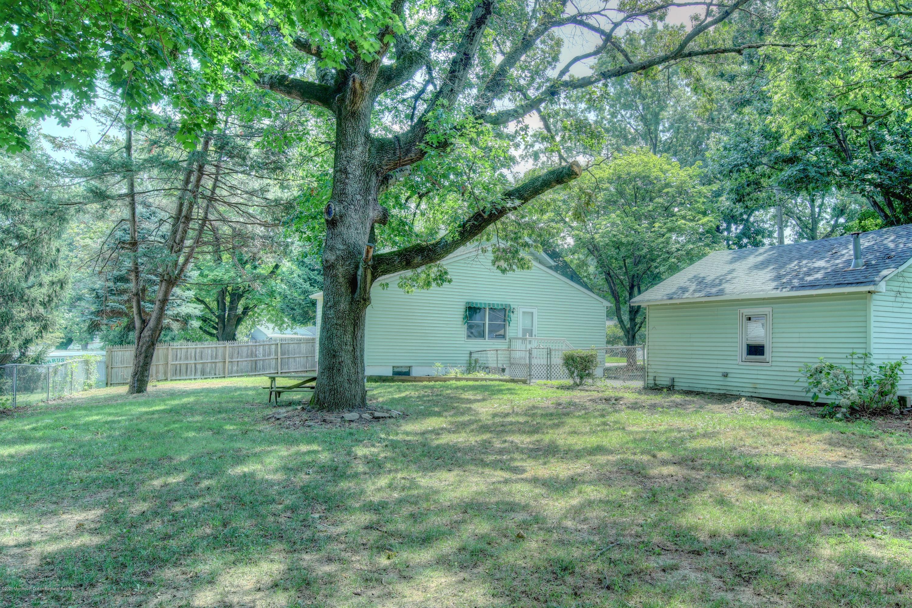 474 E Road Belford, NJ 07718 - Photo 24 of 32 a house with a tree in front of it