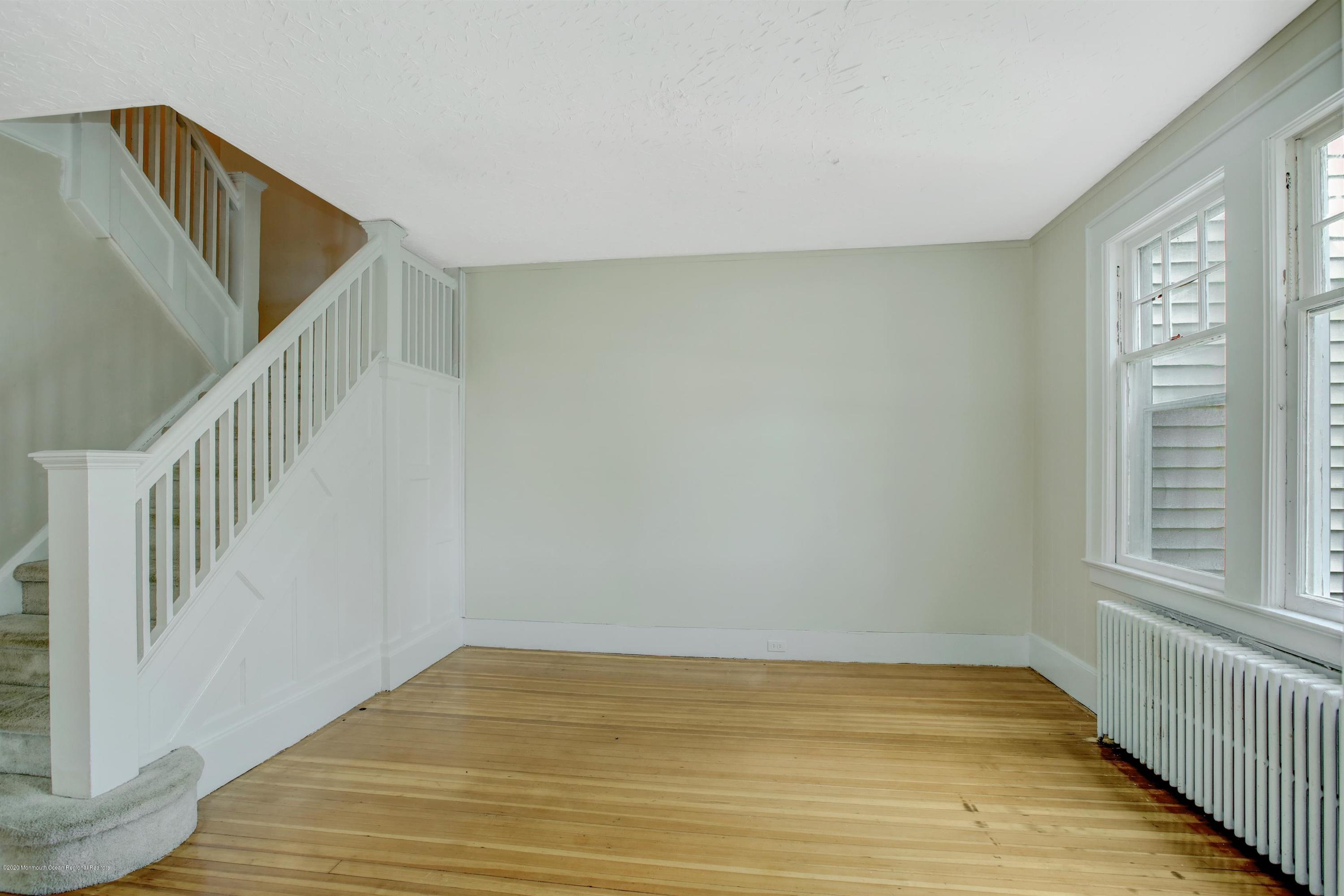 474 E Road Belford, NJ 07718 - Photo 5 of 32 a view of an empty room with wooden floor and a window