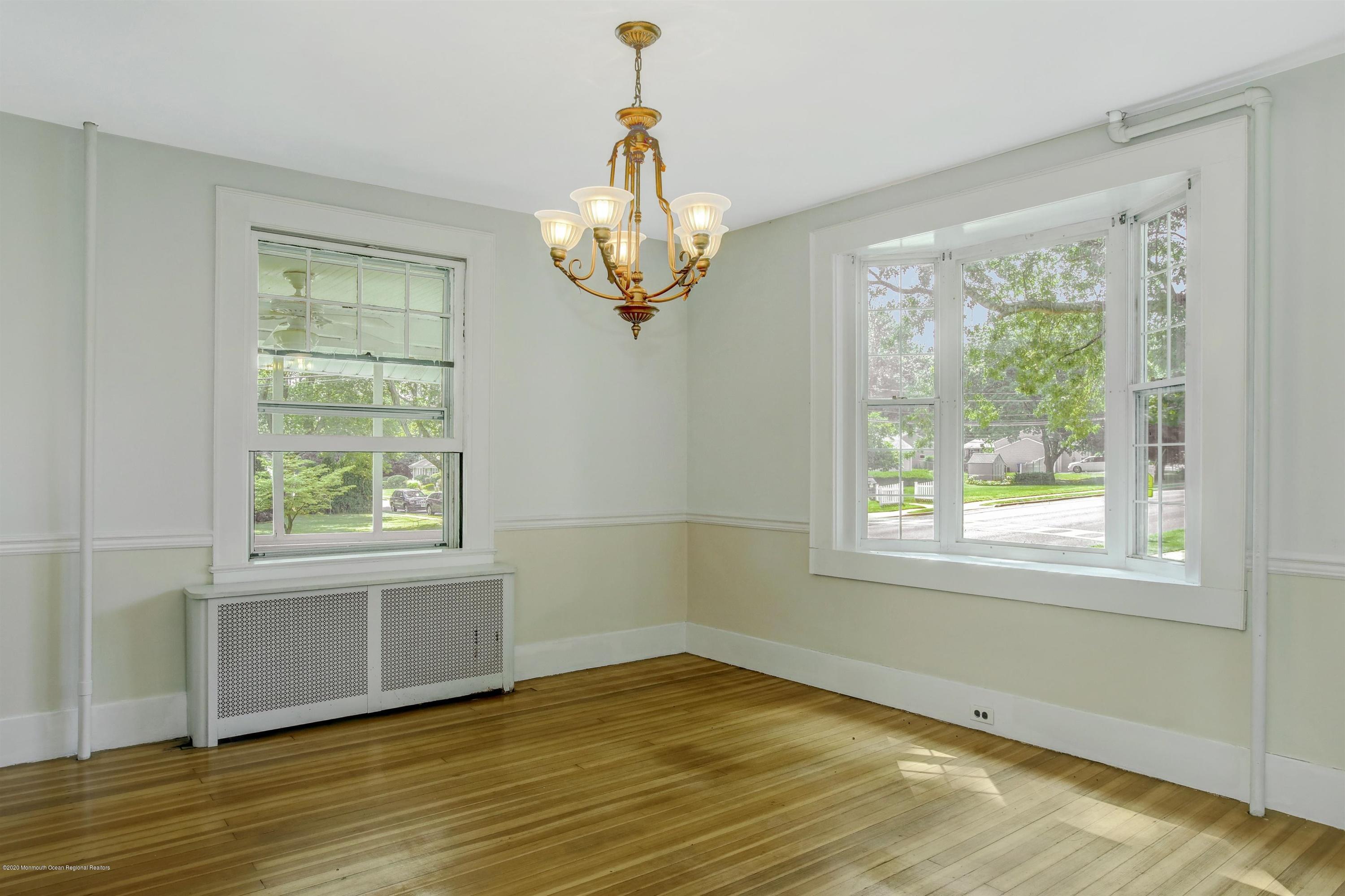 474 E Road Belford, NJ 07718 - Photo 6 of 32 a view of an empty room with wooden floor and a window