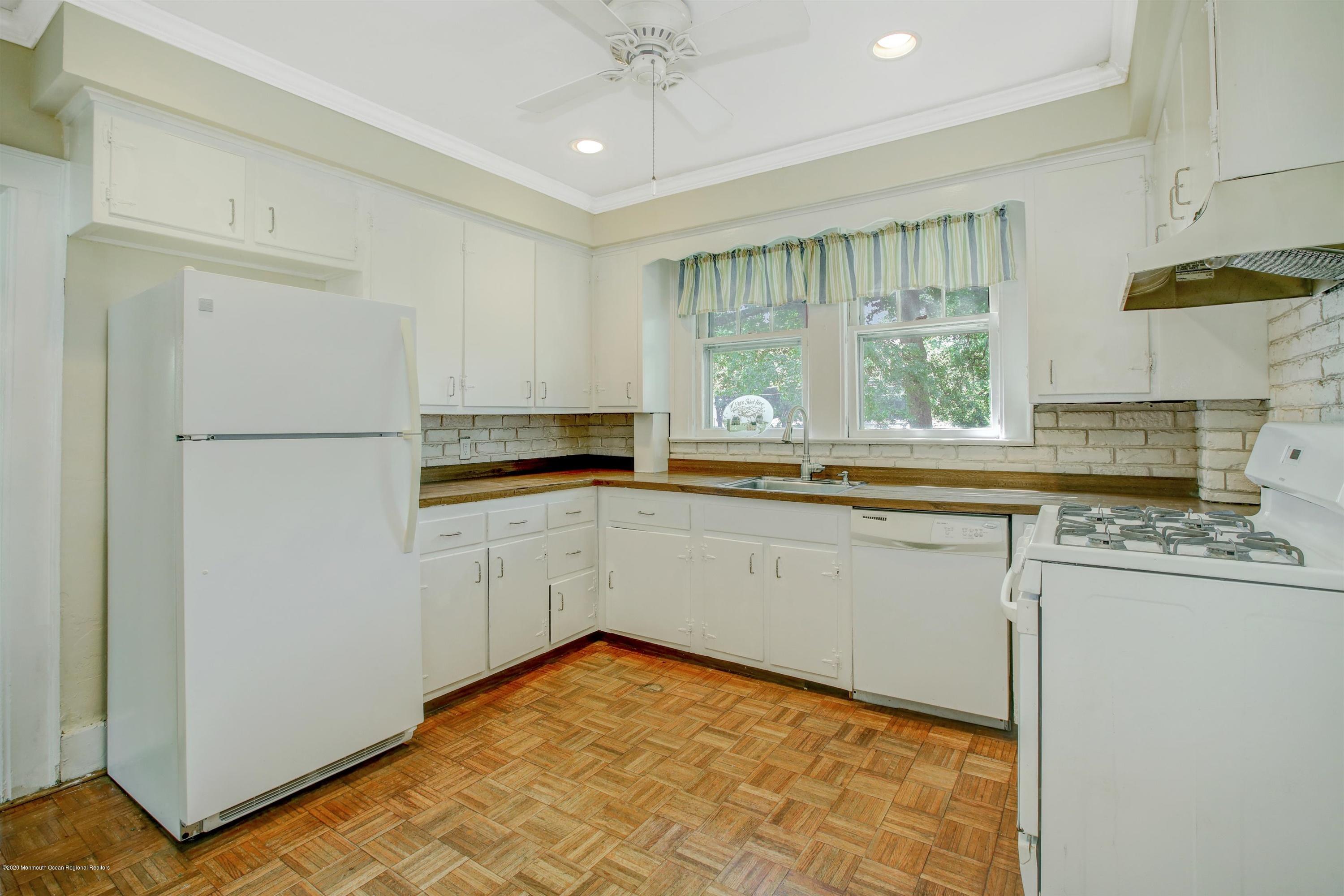 474 E Road Belford, NJ 07718 - Photo 9 of 32 a kitchen with a refrigerator a stove a sink and a window