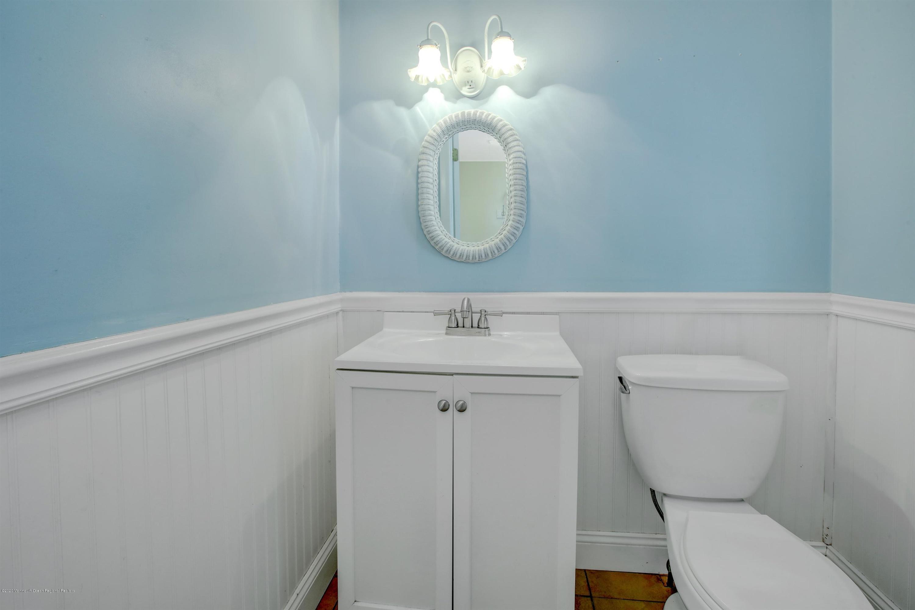 474 E Road Belford, NJ 07718 - Photo 10 of 32 a bathroom with a toilet a sink and mirror
