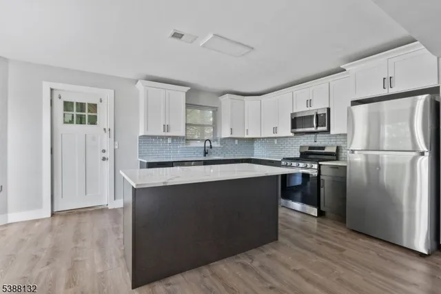 a kitchen with a refrigerator stove and microwave