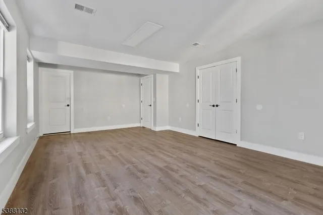 a view of an empty room and wooden floor