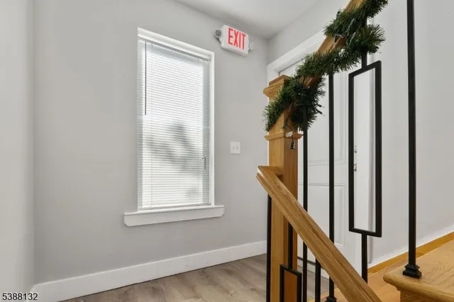 a view of staircase with railing and a potted plant