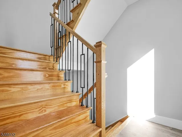 a view of staircase with white walls and a window