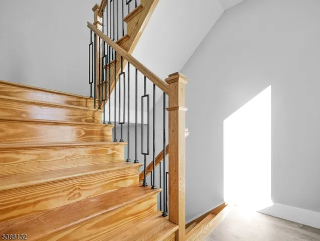 a view of staircase with white walls and a window