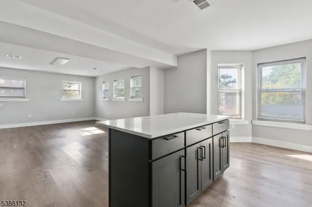 a kitchen with a stove a sink and a window
