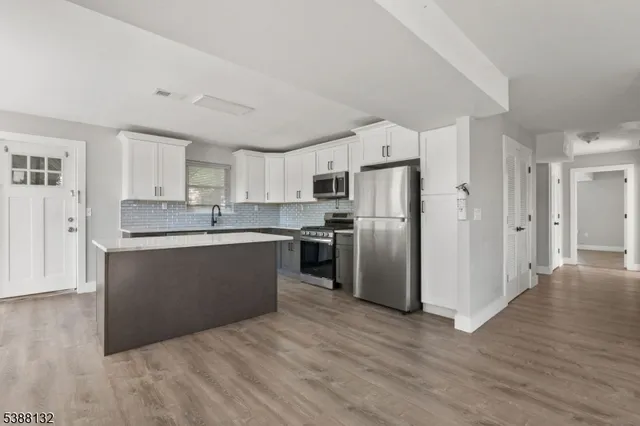 a kitchen with a refrigerator and a sink