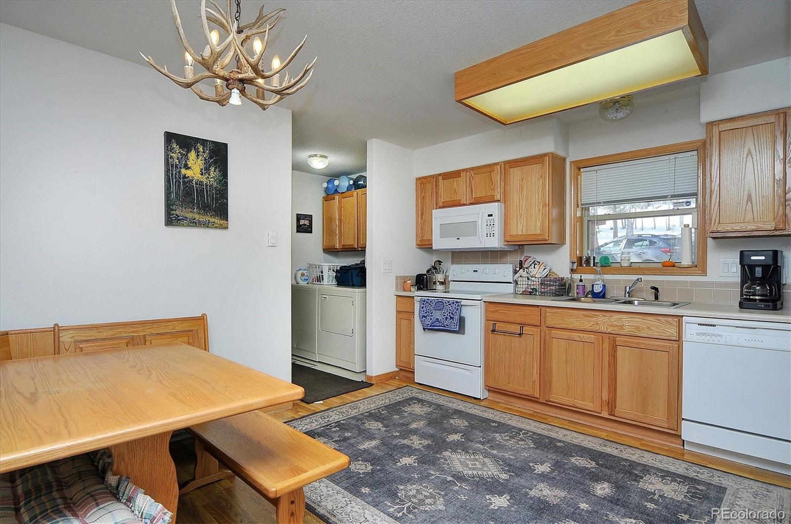 1733 Blacksmith Road Hartsel, CO 80449 - Photo 12 of 22 a kitchen with stainless steel appliances kitchen island granite countertop a stove a sink dishwasher and a refrigerator