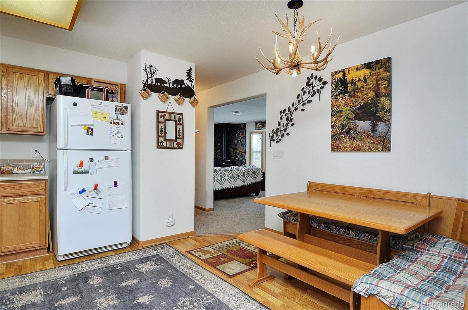 1733 Blacksmith Road Hartsel, CO 80449 - Photo 13 of 22 a bedroom with furniture and a chandelier