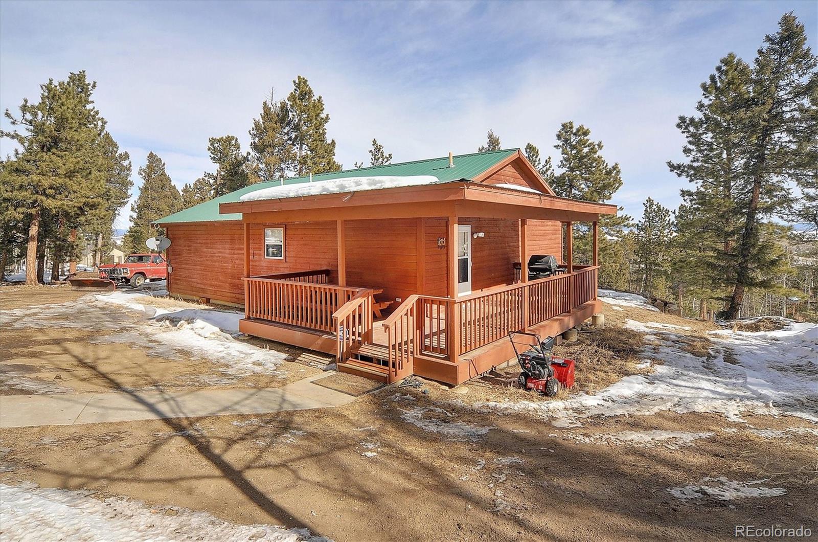 1733 Blacksmith Road Hartsel, CO 80449 - Photo 3 of 22 a view of a house with a yard and garage