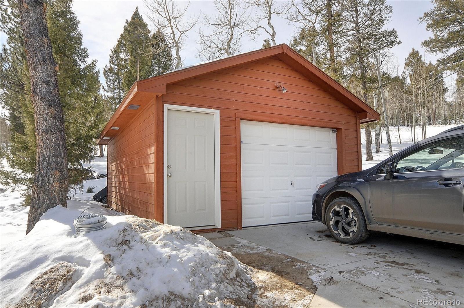1733 Blacksmith Road Hartsel, CO 80449 - Photo 4 of 22 a blue car parked in front of a house