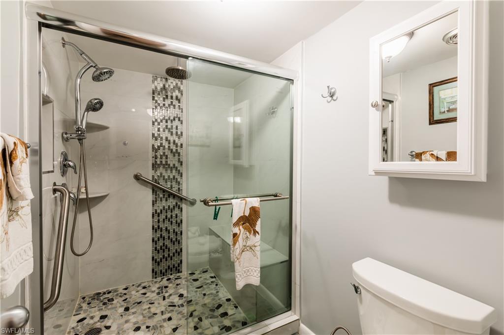 921 Seagrape Drive, Unit 308B Marco Island, FL 34145 - Photo 13 of 19 a bathroom with a shower toilet and sink