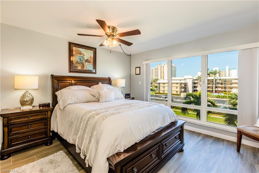 921 Seagrape Drive, Unit 308B Marco Island, FL 34145 - Photo 14 of 19 Bedroom featuring ceiling fan, access to exterior, and light hardwood / wood-style floors