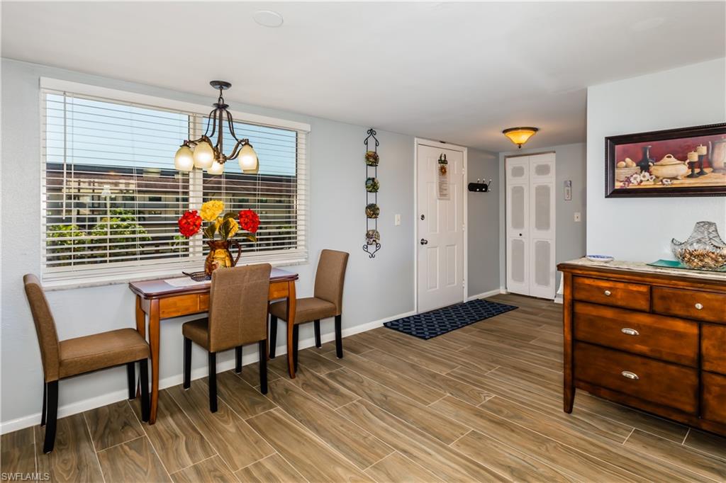 921 Seagrape Drive, Unit 308B Marco Island, FL 34145 - Photo 17 of 19 Dining space featuring a healthy amount of sunlight and a chandelier