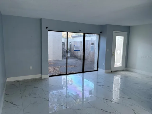 a kitchen with granite countertop a stove top oven microwave and cabinets
