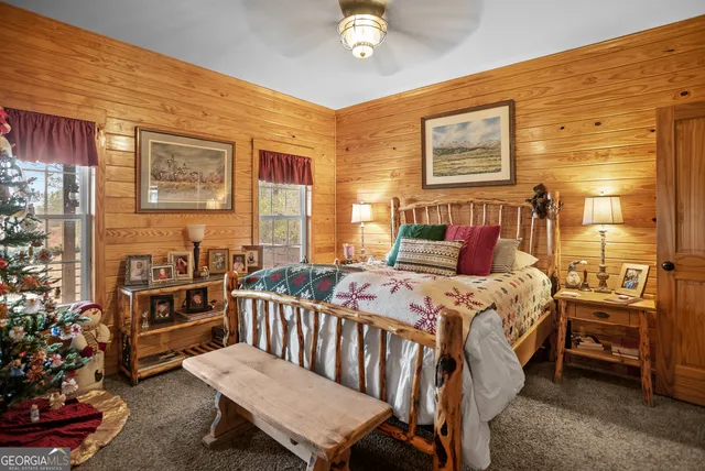 a bedroom with bed and paintings on the wall