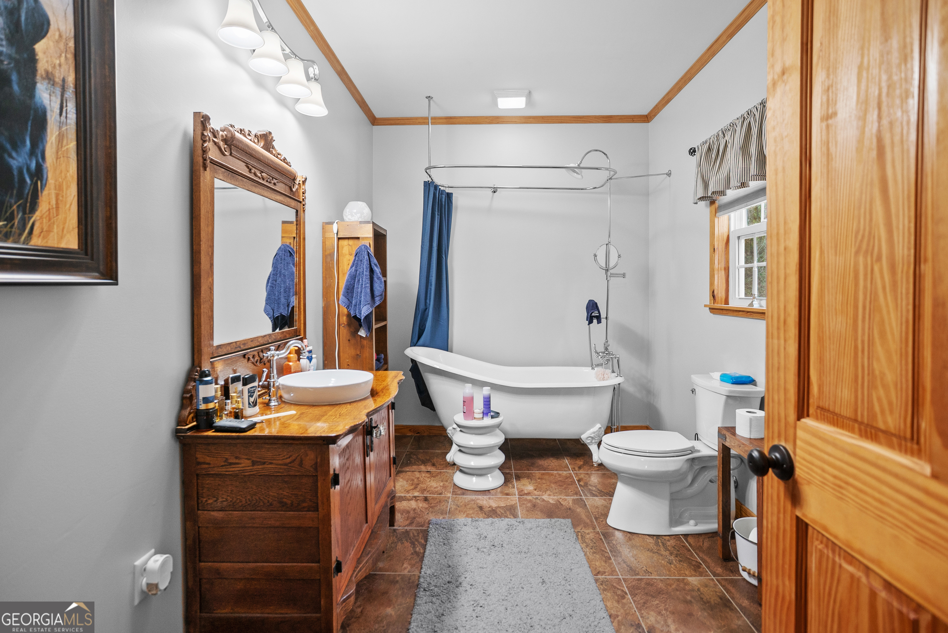 418 Oglesby Pond Road Portal, GA 30450 - Photo 16 of 56 a bathroom with a toilet sink and mirror