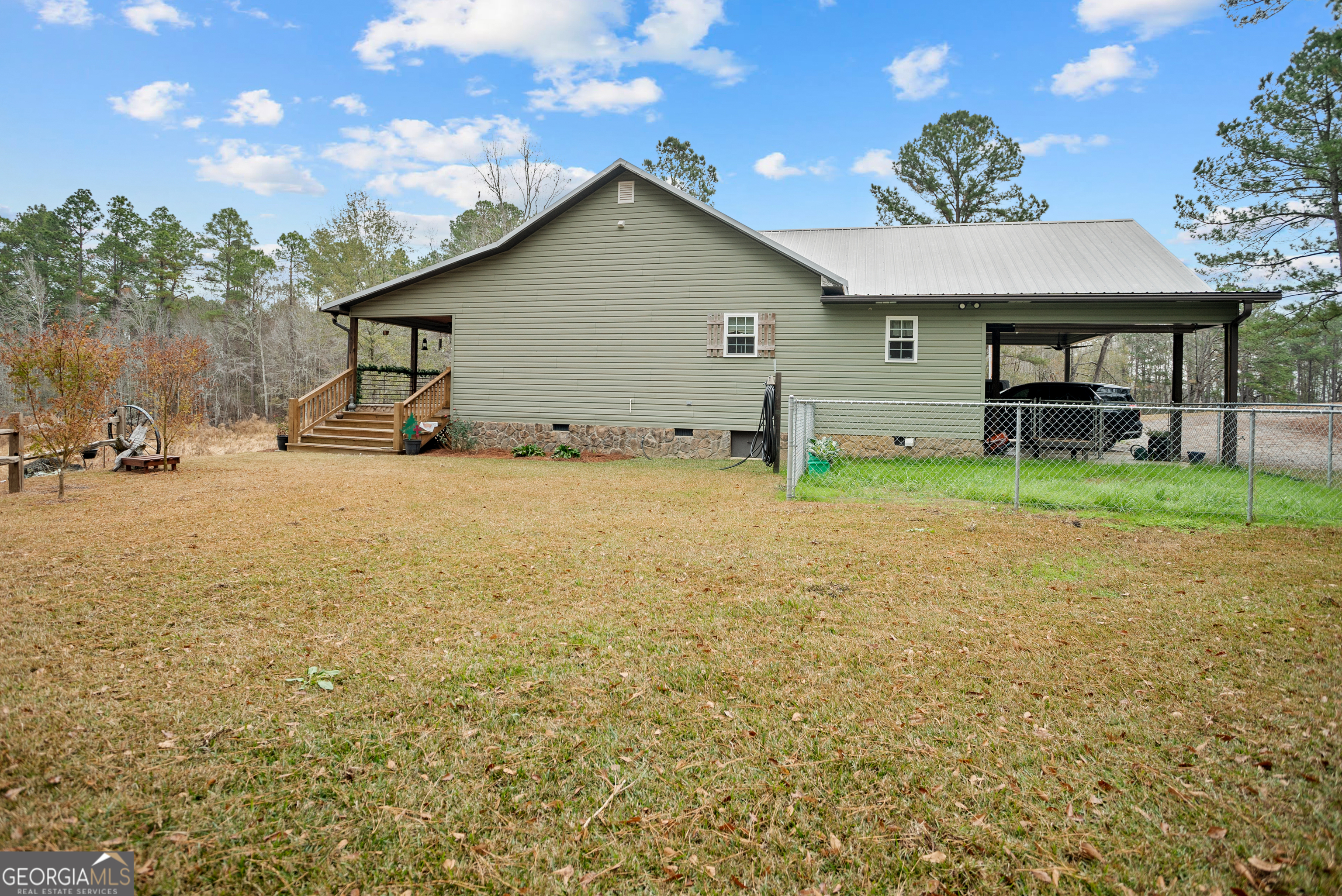 418 Oglesby Pond Road Portal, GA 30450 - Photo 34 of 56 a backyard of a house with table and chairs