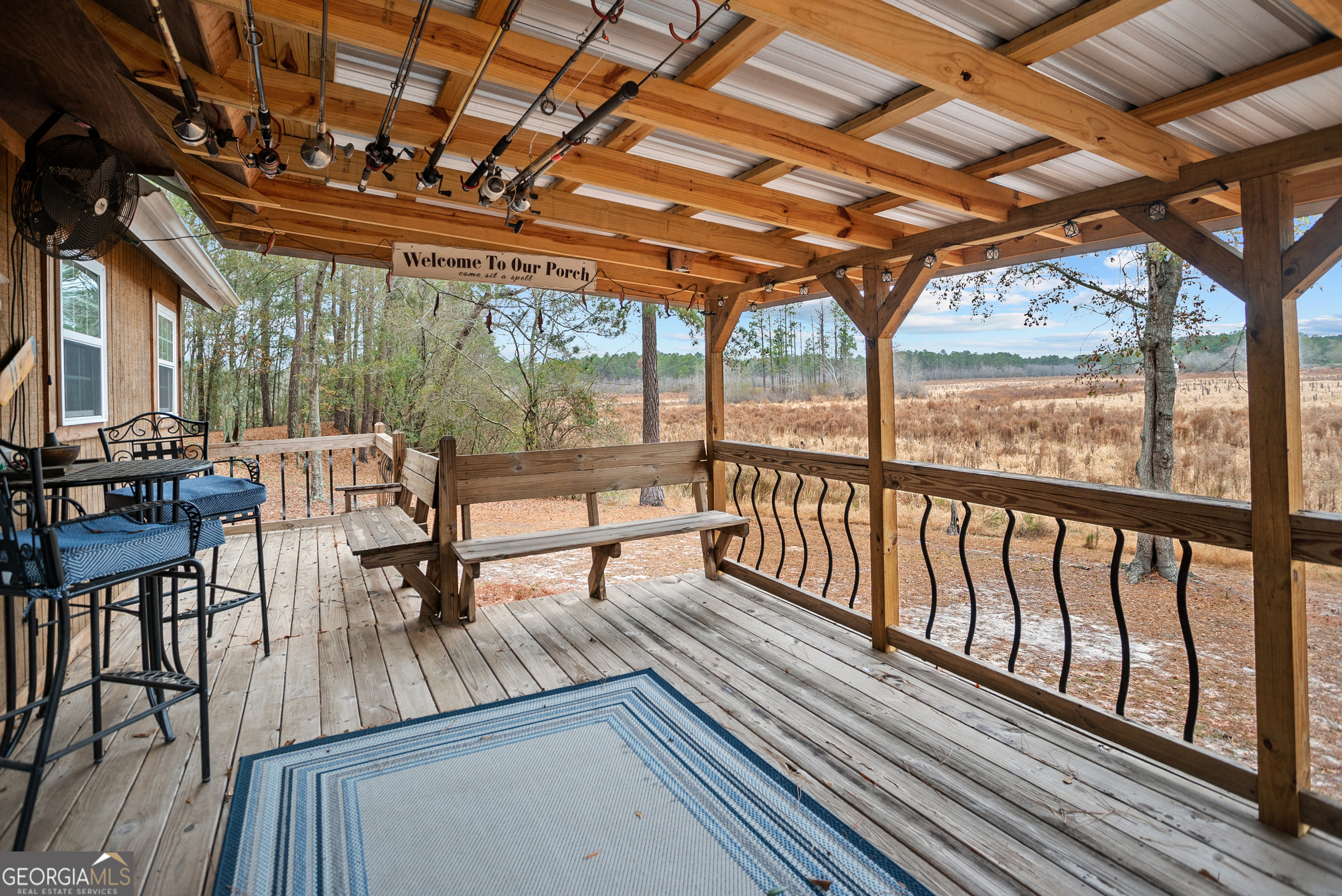 418 Oglesby Pond Road Portal, GA 30450 - Photo 38 of 56 a sitting area with furniture on wooden deck