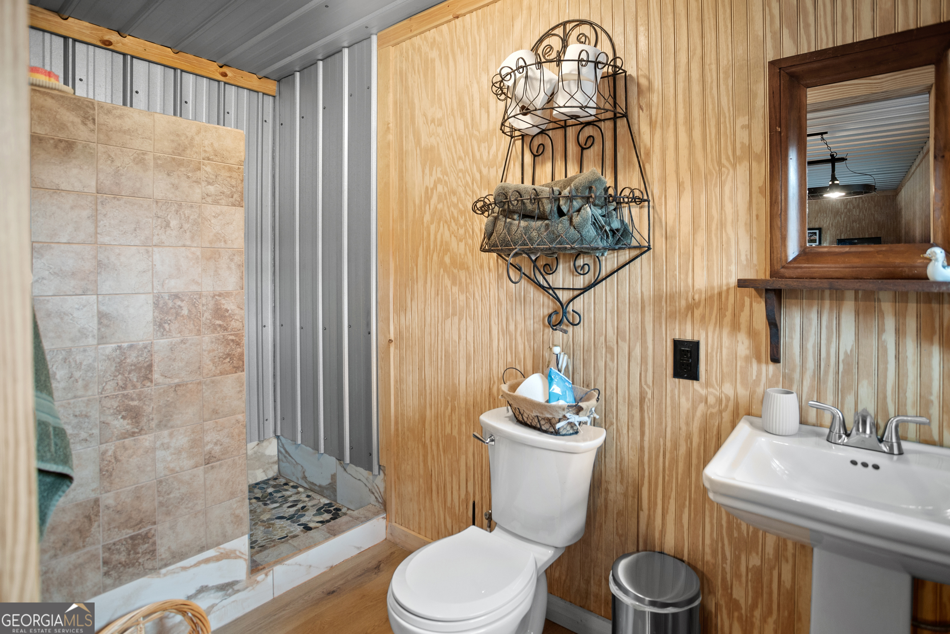 418 Oglesby Pond Road Portal, GA 30450 - Photo 44 of 56 a bathroom with a toilet a sink and a mirror