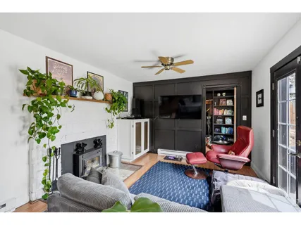 a living room with furniture kitchen view and a potted plant