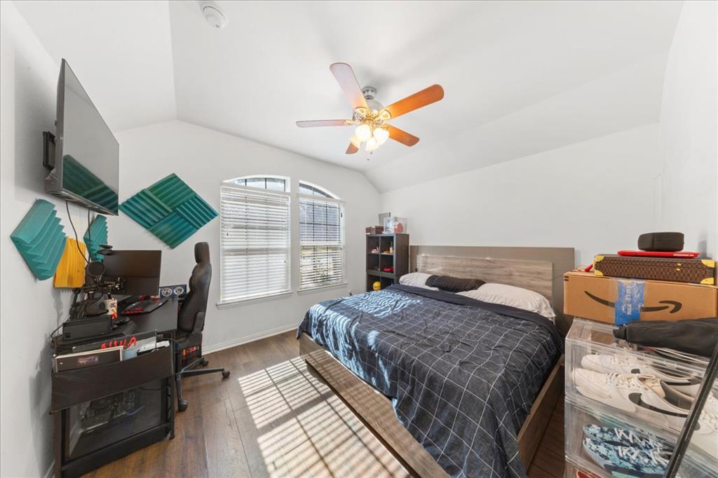 349 Razzmatazz Trail Buda, TX 78610 - Photo 11 of 27 Rich hardwood floors complement the natural light streaming into this versatile sleeping and study space.