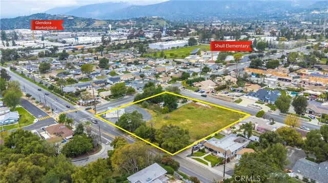 an aerial view of residential houses with outdoor space and swimming pool