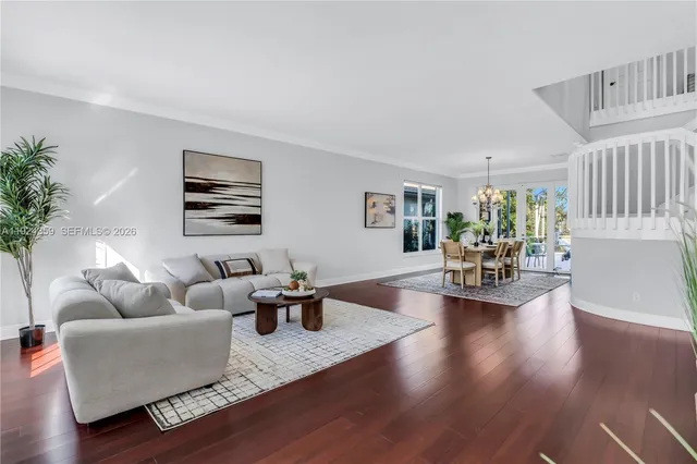 a living room with furniture wooden floor and a lamp