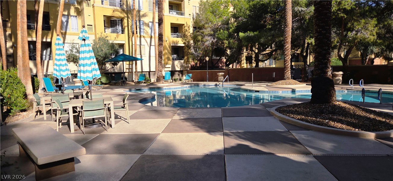 210 East Flamingo Road, Unit 208 Las Vegas, NV 89169 - Photo 29 of 42 An inviting pool area awaits, perfect for leisurely afternoons under the sun.