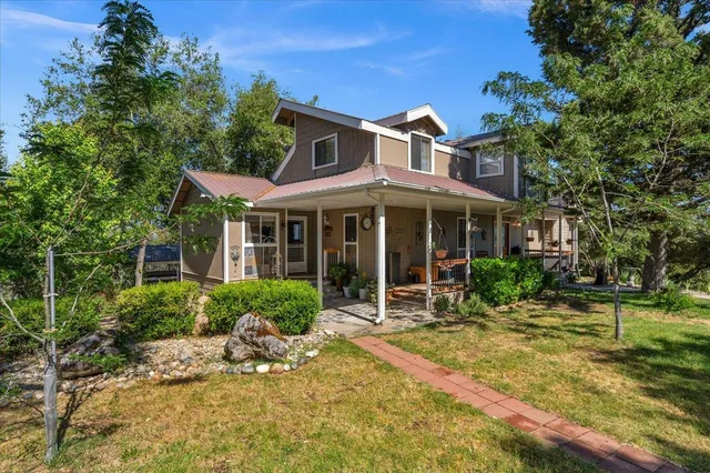 a front view of a house with a garden