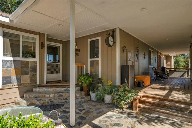 a view of a dining room with furniture a chandelier and wooden floor