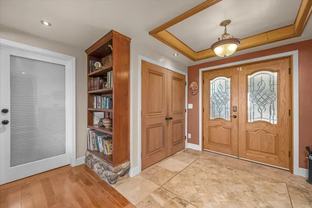 a kitchen with granite countertop a refrigerator and a stove top oven