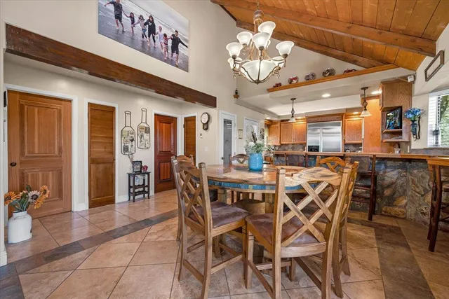 a spacious bedroom with a bed and a chandelier