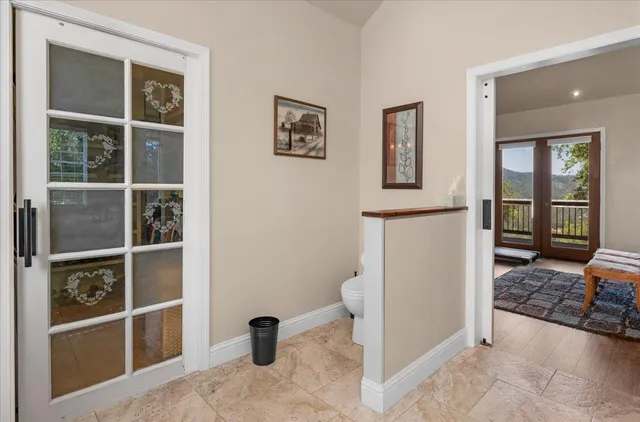 a view of a patio with table and chairs and a large tree