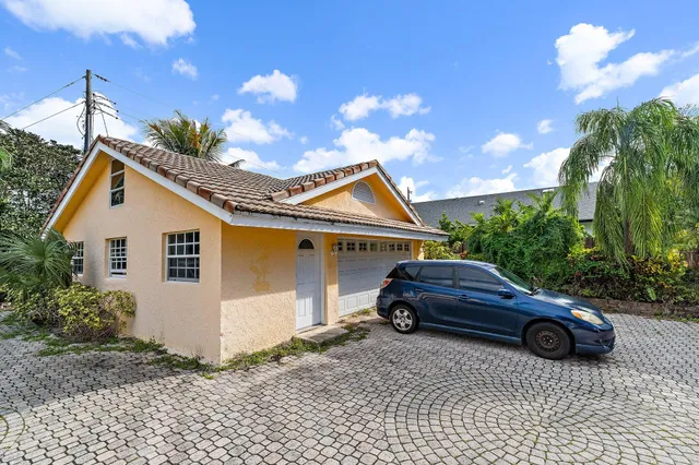 a front view of a house with a garden