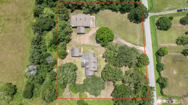 an aerial view of a house with yard