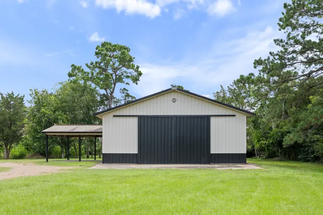 a front view of a house with yard and green space