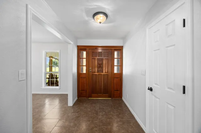 a view of a hallway with wooden shelves